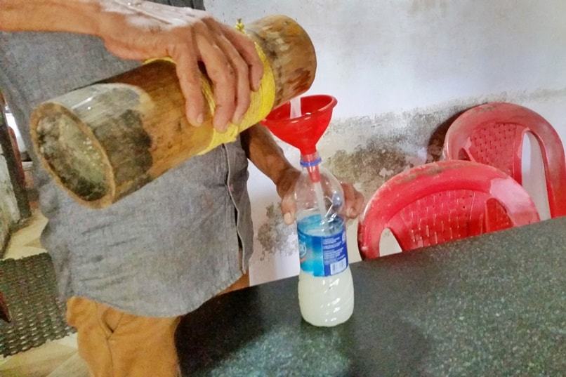 Alcohol in Alleppey: Kerala palm wine toddy in water bottle. Backpacking Kerala, India